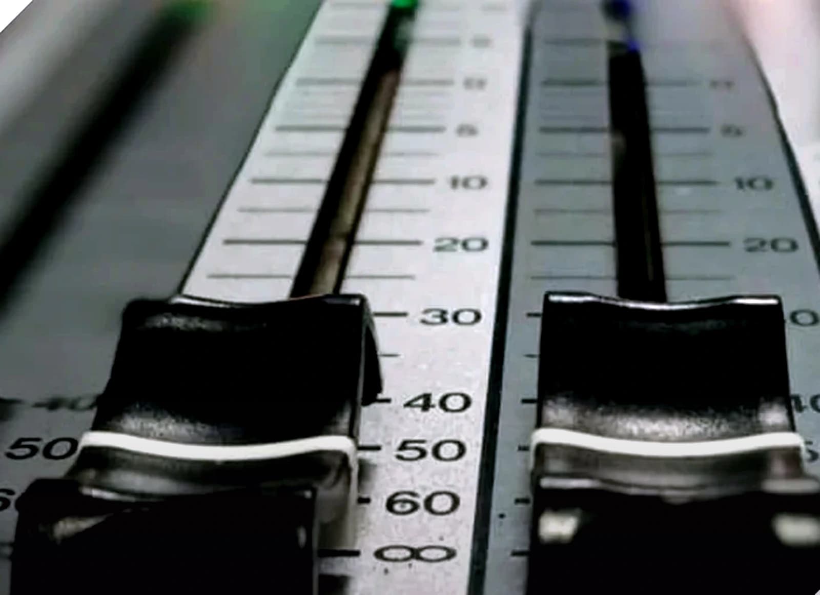 Close-up of an audio mixing desk used for live sound production.